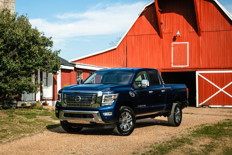 A 2021 Nissan Titan XD parked near a barn