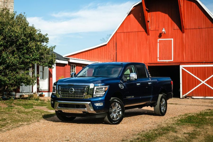 A 2021 Nissan Titan XD parked near a barn