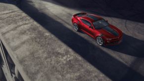 The 2021 Chevrolet Camaro in red surrounded by shadows