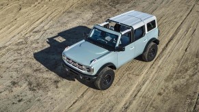 A powder-blue 2021 Ford Bronco SUV is shown from overhead with its roof partially removed