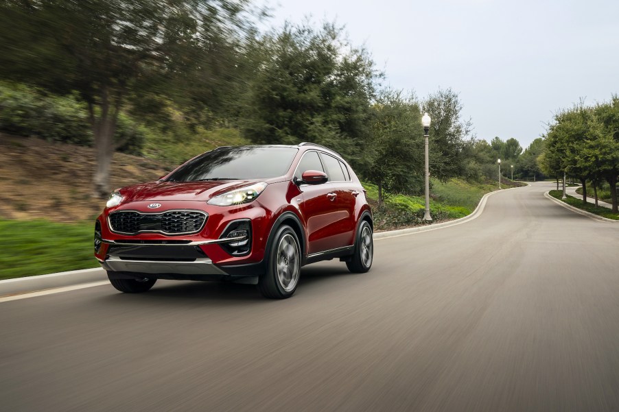 A red 2021 Kia Sportage driving