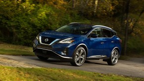 A blue 2021 Nissan Murano parked in the woods