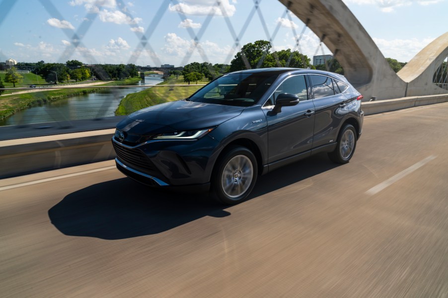 A 2021 Toyota Venza driving over a bridge on a sunny day