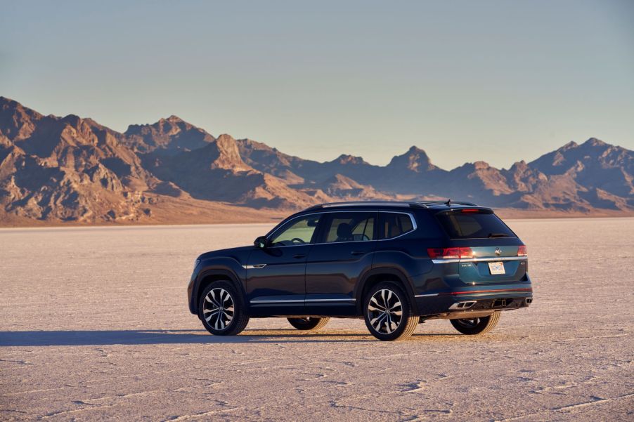 A dark blue 2021 Volkswagen Atlas SUV model parked in the middle of a desert plain