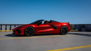 A red 2021 Chevy Corvette parked with a blue sky behind it.