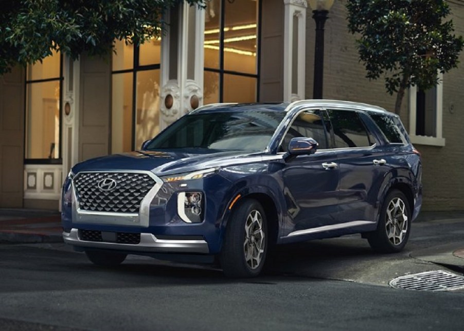 A navy blue 2021 Hyundai Palisade outside of a building.