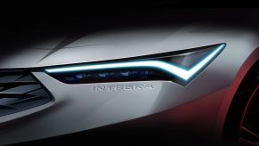 The teaser image of a white 2022 Acura Integra