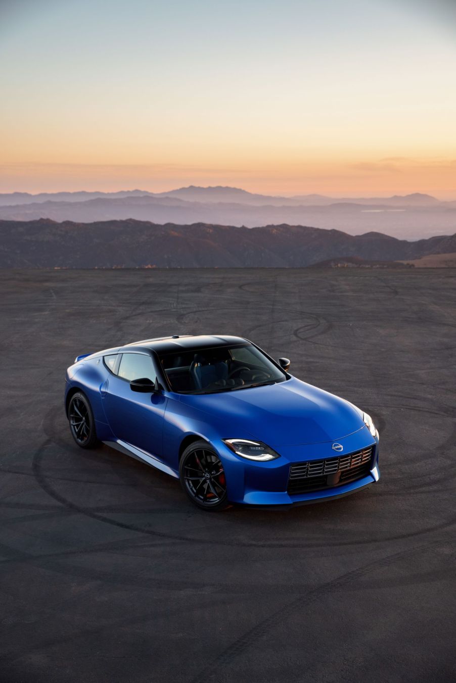 An overhead view of a blue 2023 Nissan Z on a mountainside road