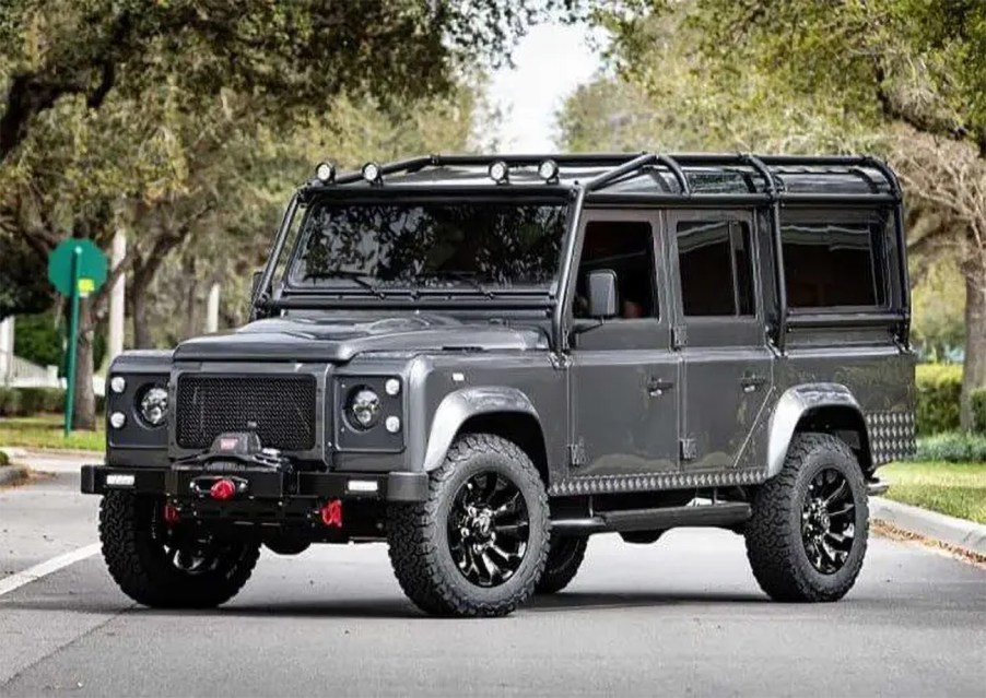 A grey Land Rover defender bulletproof car.