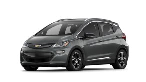 A dark gray 2021 Chevy Bolt against a white background.