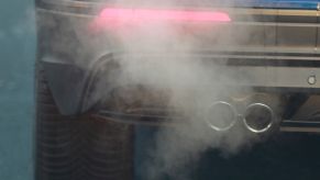 A car emitting gas exhaust fumes from its tailpipe in Cologne, Germany