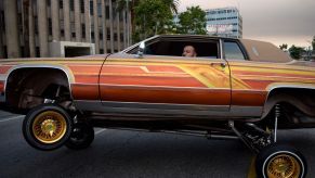 An orange car illustrating car modifications you can do to a car regarding suspension.