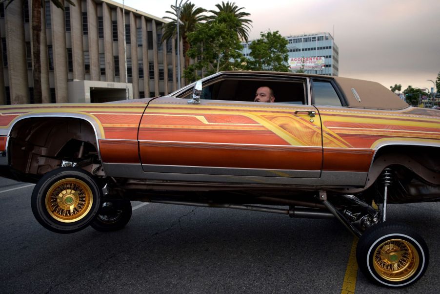 An orange car illustrating car modifications you can do to a car regarding suspension.