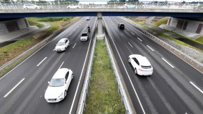 Cars driving down a highway, if you want your car to last, breaking in a new car is a good idea