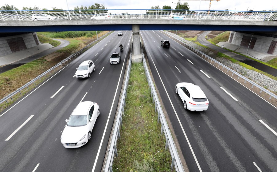 Cars driving down a highway, if you want your car to last, breaking in a new car is a good idea