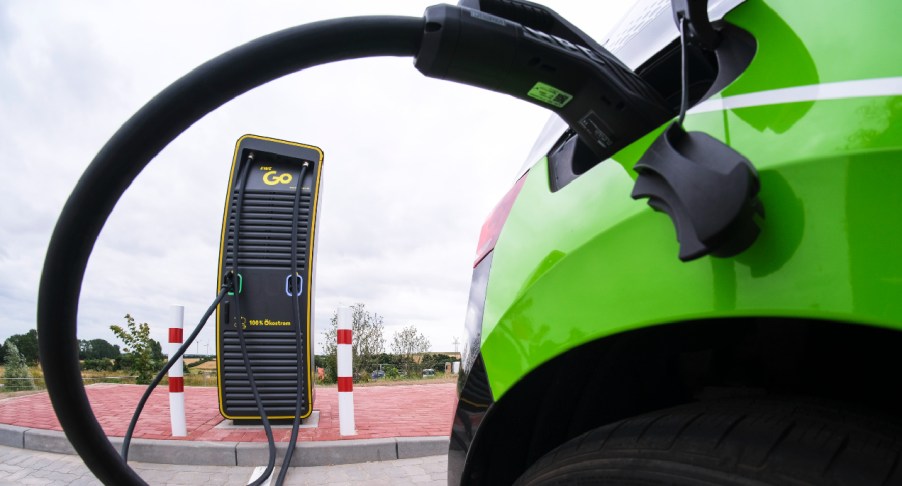 An electric car stands at a charging station.