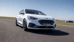 White Ford Focus ST driving on a race track.