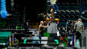 Autoworkers assemble the chassis of full-size pickup trucks at the General Motors plant in Flint, Michigan, in 2019