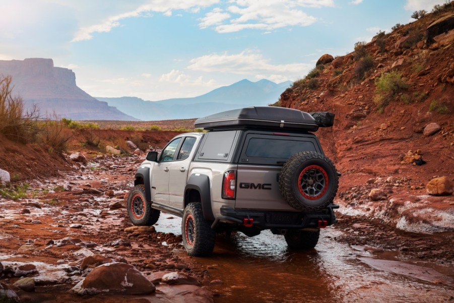 Silver GMC Canyon AT4 OVRLANDX Off-Road Concept driving across a stream