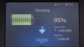 A display shows the predicted EV range for a vehicle plugged in