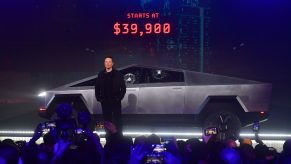 Tesla co-founder and CEO Elon Musk stands in front of the newly unveiled all-electric battery-powered Tesla's Cybertruck