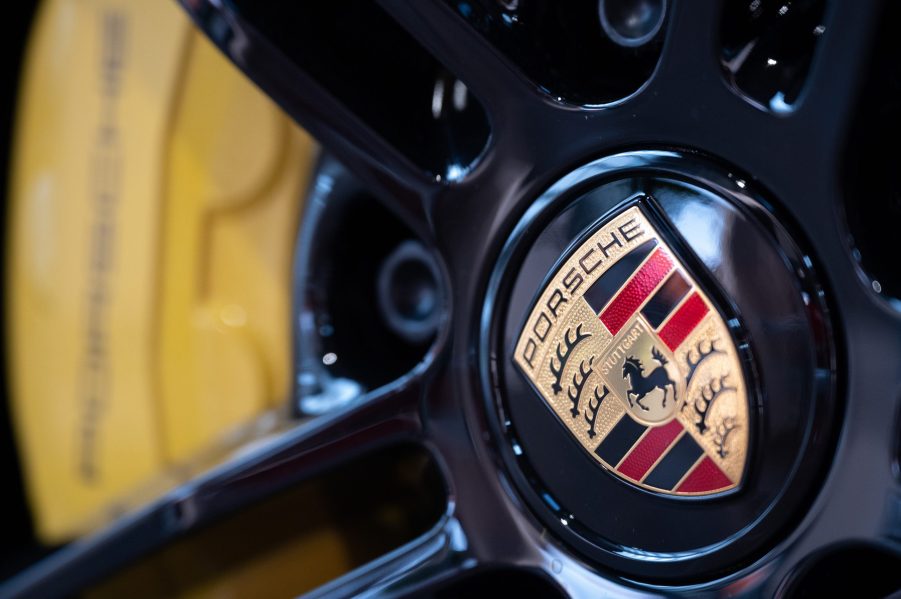 The wheel of a Porsche 911 featuring the legendary badge