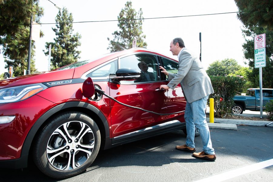 Congressman Adam Schiff plugs in his Chevy Bolt during the unveiling of new electric vehicle charging ports in Downtown Burbank on Monday, July 12, 2021.