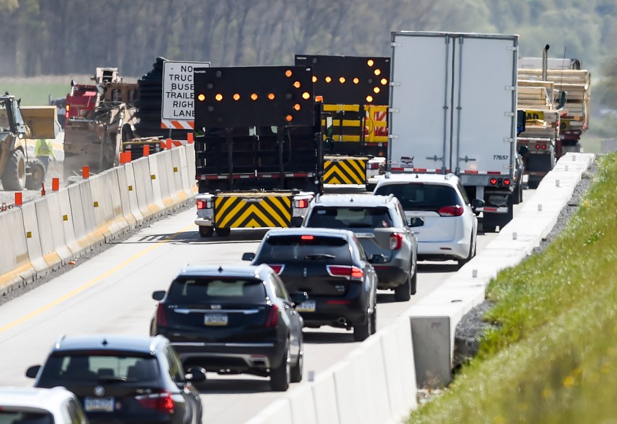 Cars merge down to a single lane as they approach roadwork