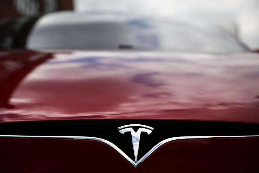 The badge of a Tesla Model S sedan in red