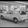 A white 1970 AMC Gremlin in a garage.