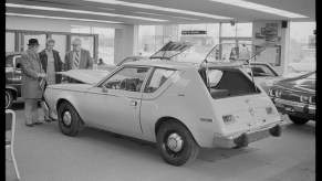 A white 1970 AMC Gremlin in a garage.