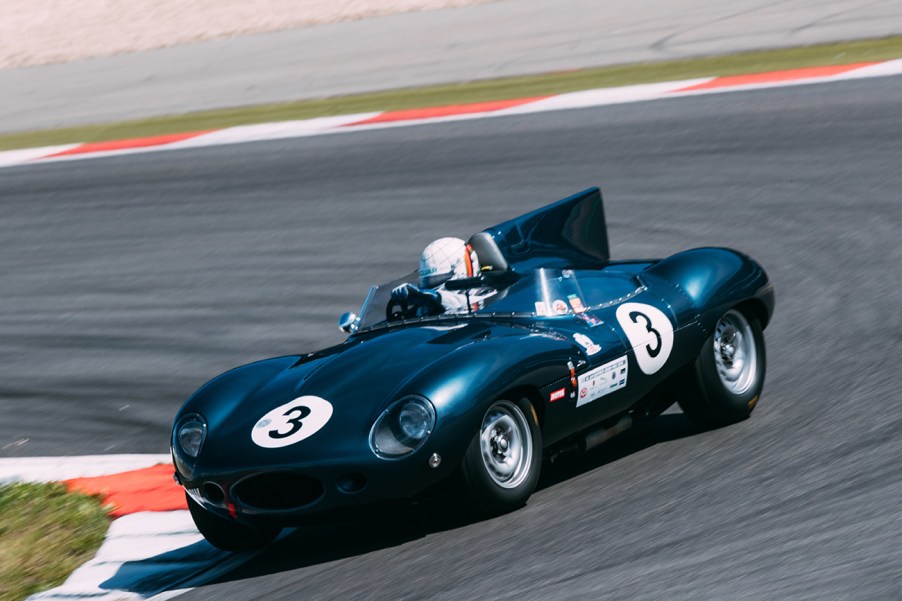 1954 Jaguar D Type roadster race car racing on a track.