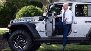 Joe Biden exiting a Jeep Wrangler Rubicon 4xe at the White House for a talk on climate and EVs