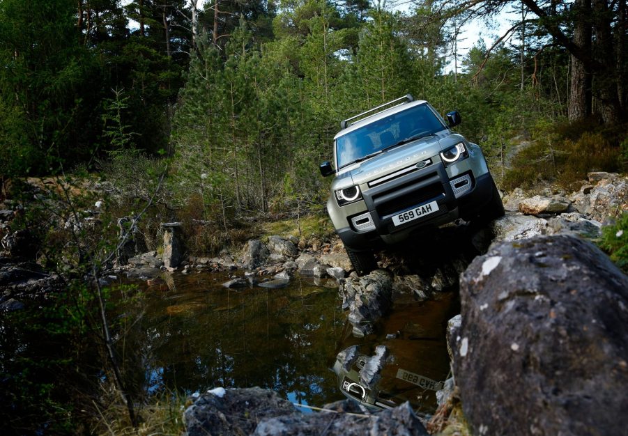 2021 Land Rover Defender 90 parked next to a lake