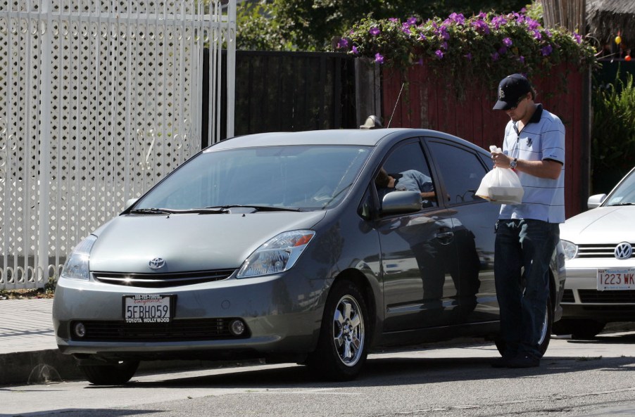 Leonardo DiCaprio getting into his Toyota Prius, one of the cheapest cars owned by one of the world's richest celebrities