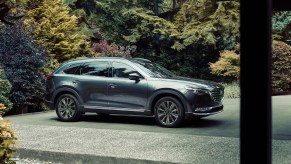 A metallic silver 2021 Mazda CX-9 parked outside.