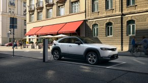 White 2022 Mazda MX-30 charging while parked.