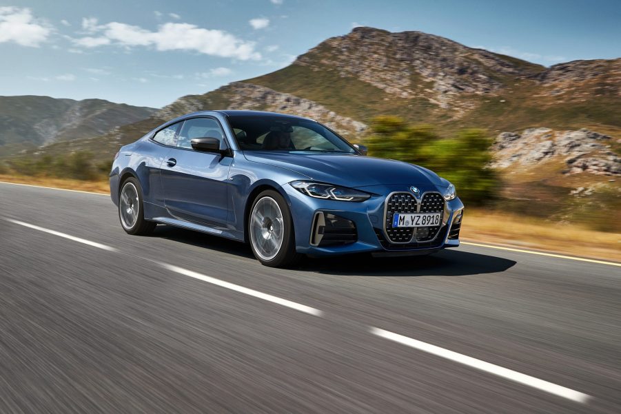 A blue 2021 BMW M440i coupe on a mountain road