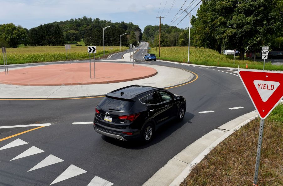 A Hyundai SUV at the yield sign intersection of a roundabout