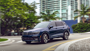 A blue 2021 Volkswagen Tiguan driving in the street