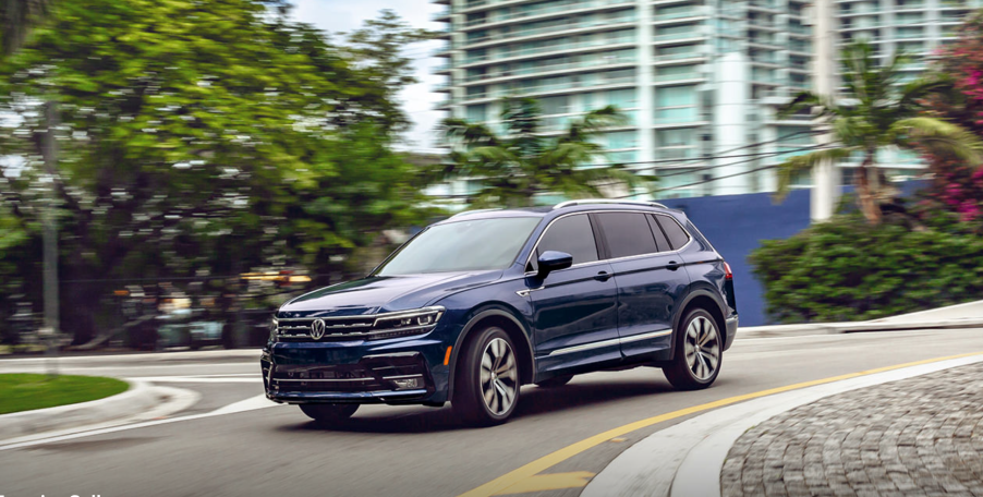 A blue 2021 Volkswagen Tiguan driving in the street