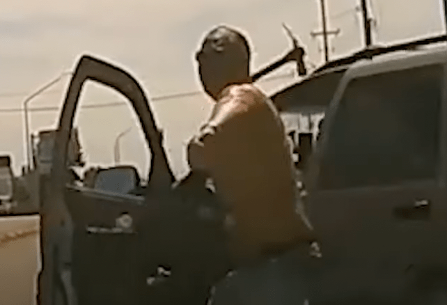 Man Throwing Pickaxe At Windshield