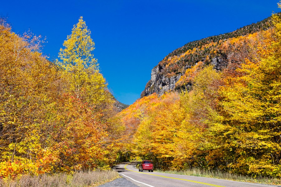 Scenic autumn drive through Smugglers Notch, one of the best scenic drives for leaf-peeping in the northeast