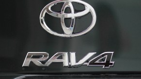 The Toyota and RAV4 logos displayed on the back of a Toyota RAV4 at a dealership in Oakland, California, in 2011