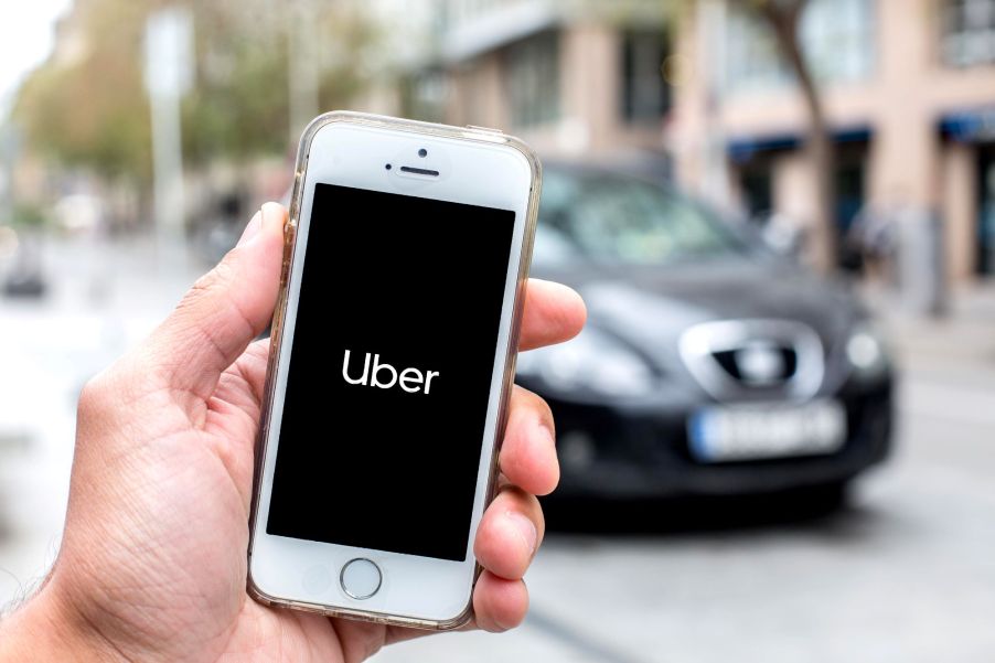 The Uber ride-share app open on a smartphone as the driver and ride arrive to pick up a passenger