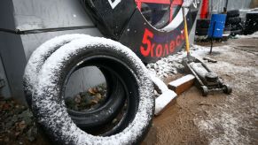 A pair of winter tires outside of an automotive garage shop