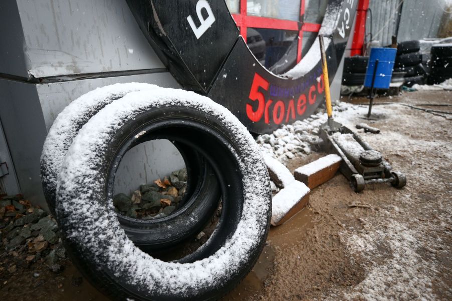 A pair of winter tires outside of an automotive garage shop