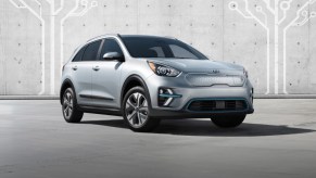 a silver 2021 kia Niro electric in a press photo against a concrete wall