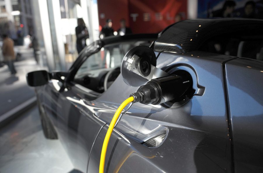 An electric cable is plugged into a Tesla Roadster Sport