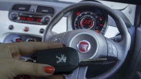 A key fob with a Fiat steering wheel behind it.